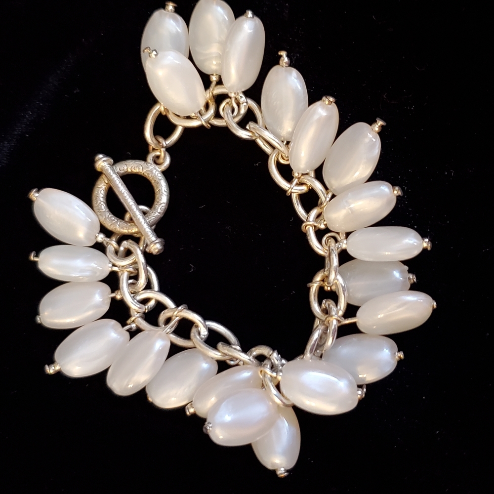 Silvertone toggle closure bracelet with oval pearly bead charms